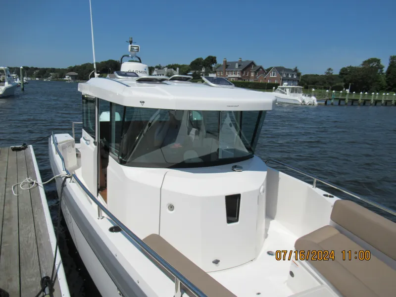 Slide: The Image of 2018 Axopar Mark II boat docked at a marina on a sunny day. - 16