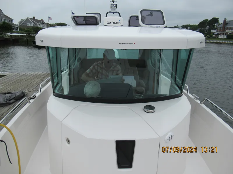 Slide: The Image of 2018 Axopar Mark II boat docked, featuring Garmin navigation system. - 22