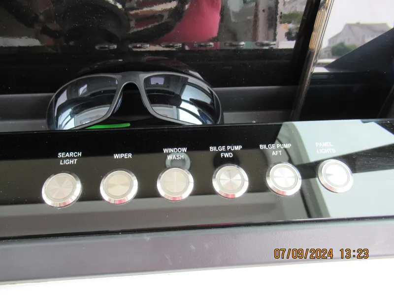 Slide: The Image of Control panel of a 2018 Axopar Mark II boat with sunglasses. - 24