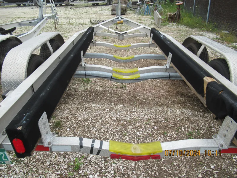 Slide: The Image of Axopar Mark II 2018 boat trailer with dual axles on gravel lot. - 25