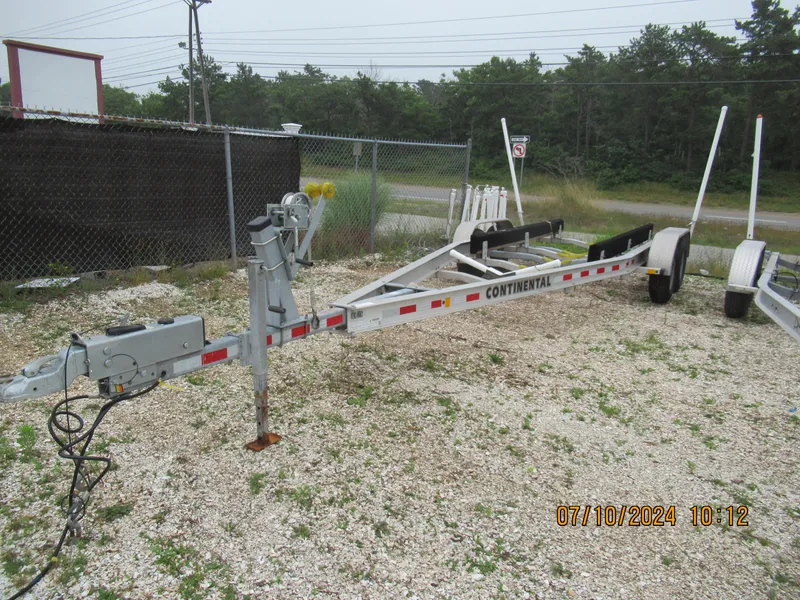 Slide: The Image of 2018 Axopar Mark II boat trailer parked on gravel lot. - 26