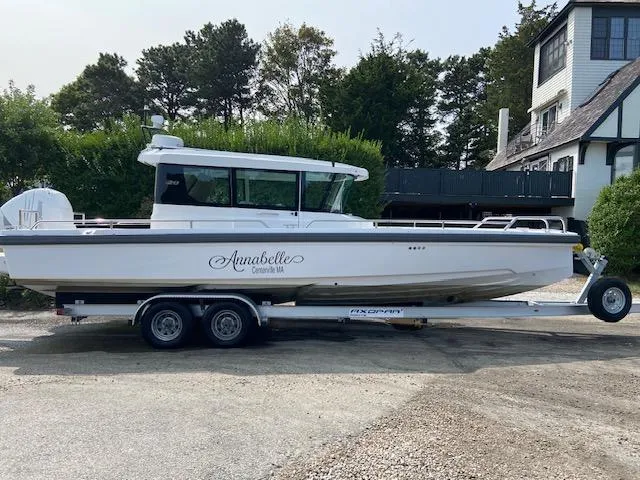 Slide: The Image of Axopar Mark II 2018 boat named Annabelle on a trailer, parked near a house. - 3