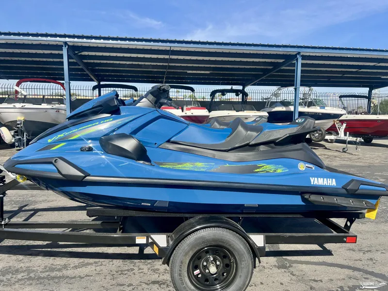 Slide: The Image of 2025 Yamaha WaveRunner VX Cruiser HO with Audio, blue, on trailer in marina. - 0