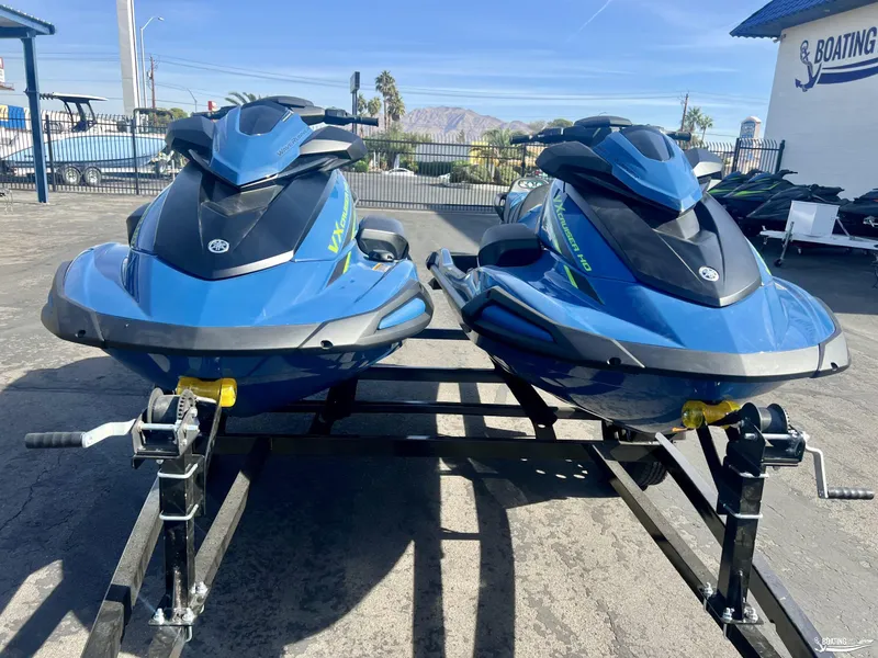 Slide: The Image of 2025 Yamaha WaveRunner VX Cruiser HO with Audio, blue, on trailer in sunny outdoor setting. - 2