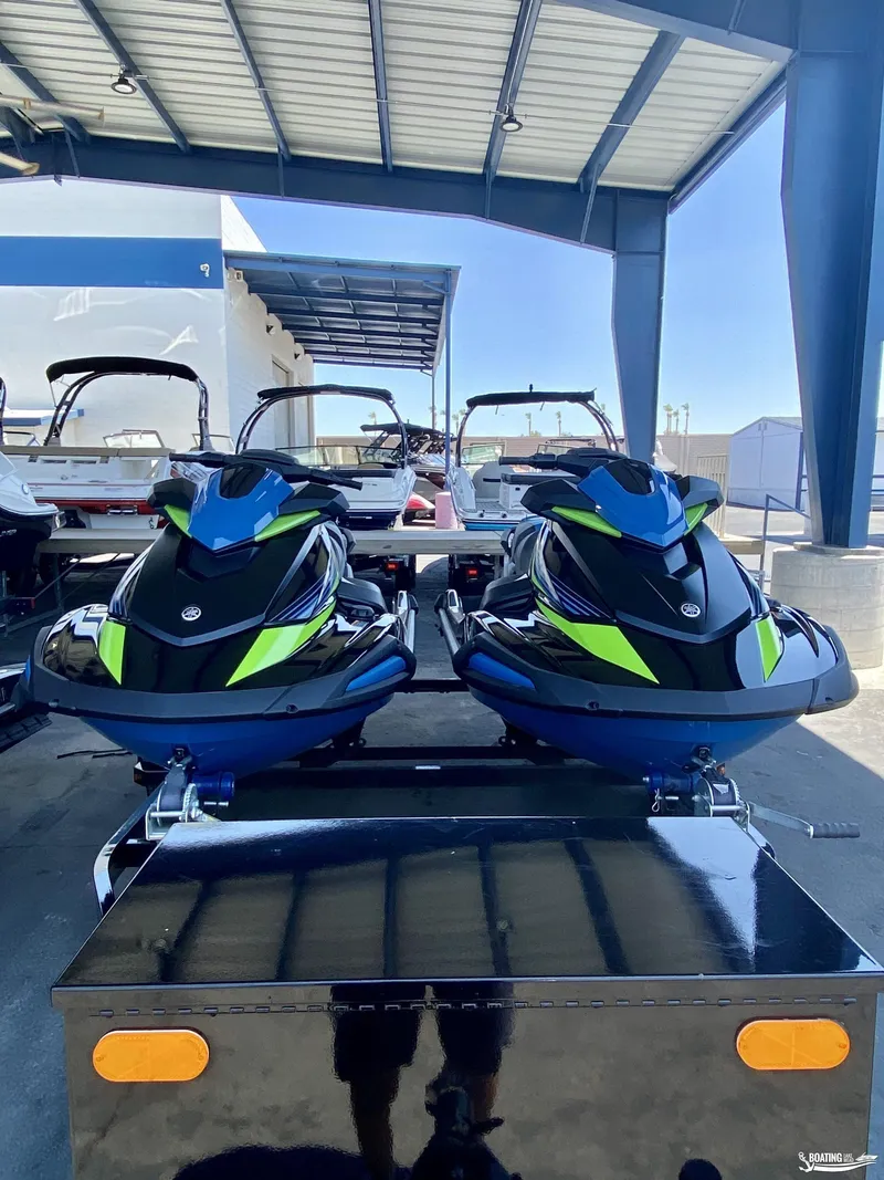 Slide: The Image of 2024 Yamaha WaveRunner VX Deluxe jet skis on a trailer in a showroom. - 3