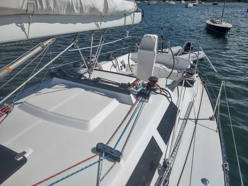 Slide: The Image of 1983 Islander 40 sailboat deck with rigging and cockpit on the water. - 12