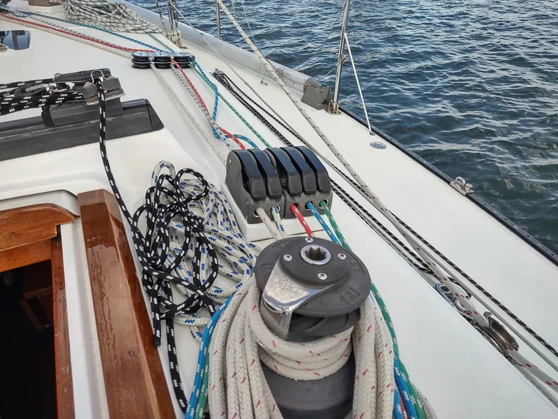 Slide: The Image of Deck of 1983 Islander 40 sailboat with ropes and winch by the sea. - 15