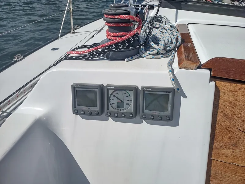 Slide: The Image of 1983 Islander 40 sailboat cockpit with navigation instruments and ropes. - 22