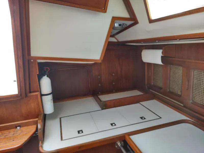 Slide: The Image of Interior cabin of 1983 Islander 40 sailboat with wooden finish and storage compartments. - 29