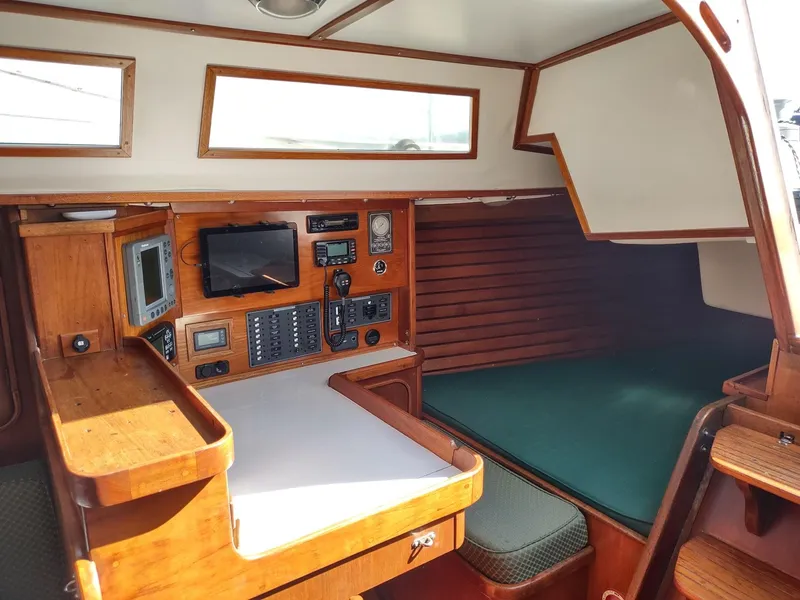 Slide: The Image of 1983 Islander 40 sailboat interior with navigation station and sleeping berth. - 30