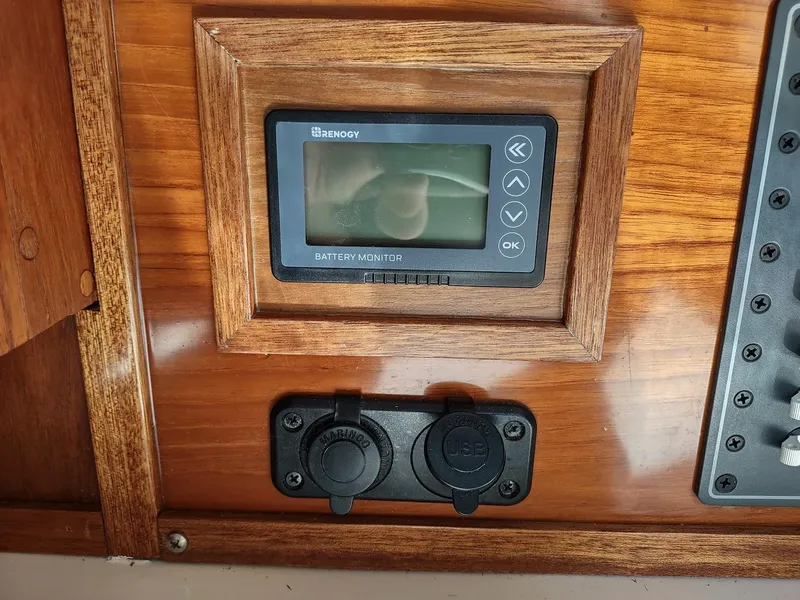 Slide: The Image of Battery monitor and power outlets on 1983 Islander 40 sailboat control panel. - 34