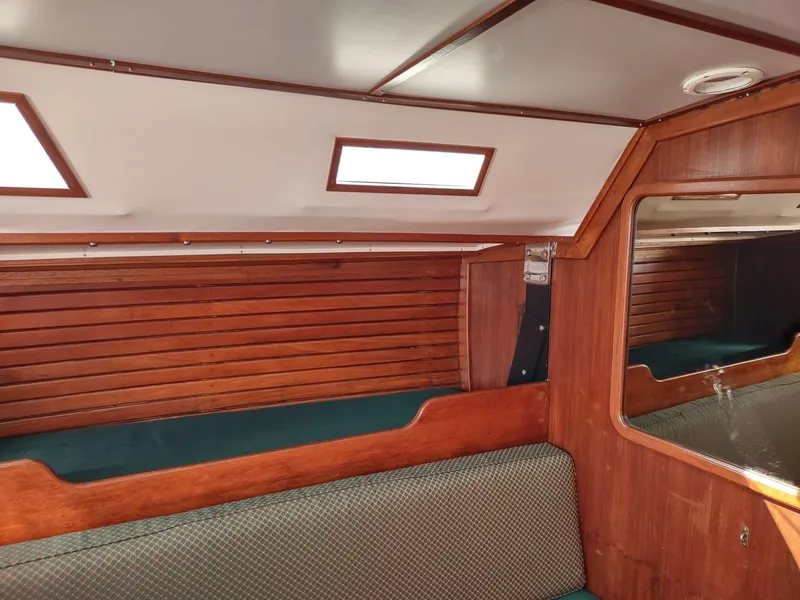 Slide: The Image of Interior cabin of 1983 Islander 40 sailboat with wooden paneling and seating. - 44