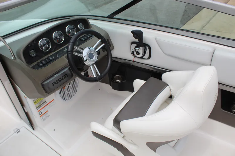 Slide: The Image of Interior of a 2011 Regal 2100 boat featuring steering wheel and dashboard controls. - 10