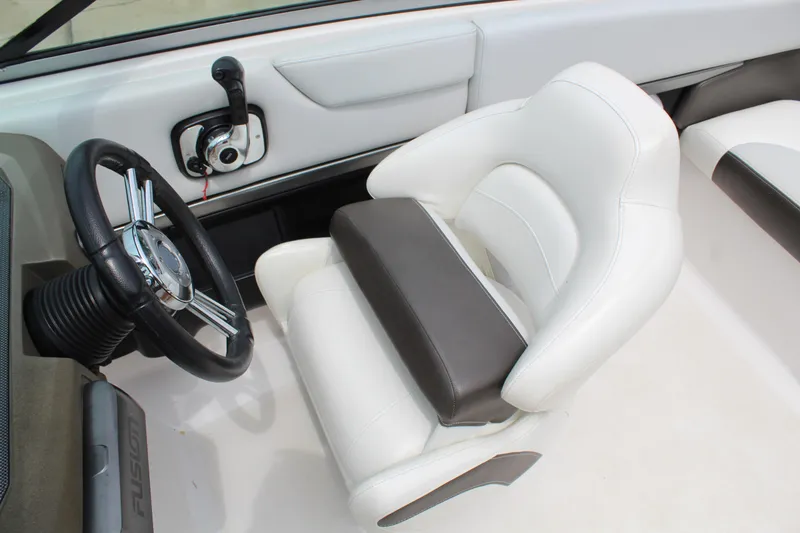 Slide: The Image of Interior of 2011 Regal 2100 boat with steering wheel and white seating. - 11