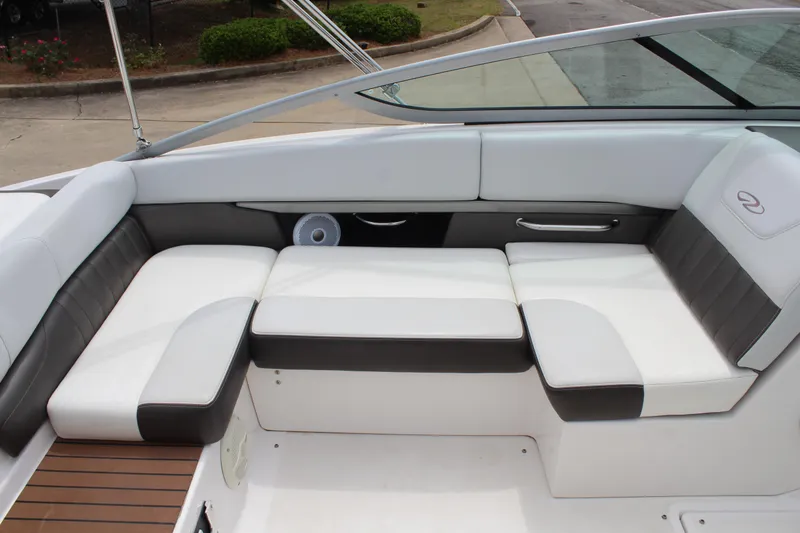 Slide: The Image of 2011 Regal 2100 boat interior with white and black seating, sleek design. - 12