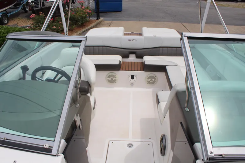 Slide: The Image of 2011 Regal 2100 boat interior with seating and steering wheel, showcasing modern design. - 15