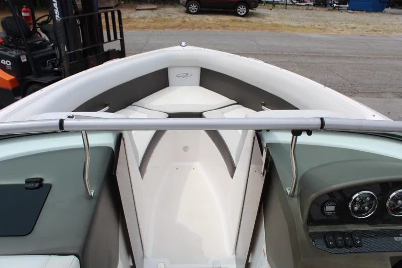 Slide: The Image of 2011 Regal 2100 boat interior with seating and dashboard view. - 16