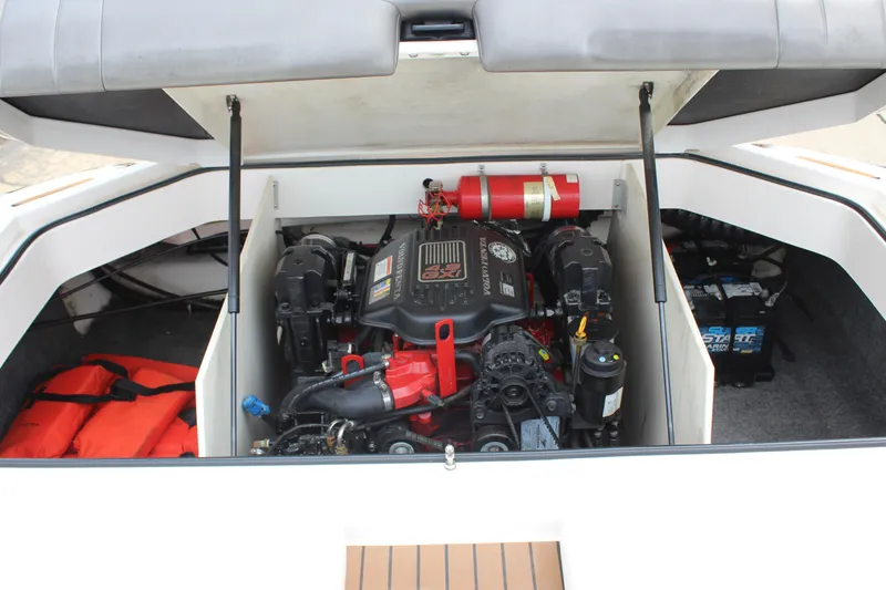 Slide: The Image of 2011 Regal 2100 boat engine compartment with safety equipment and battery. - 19