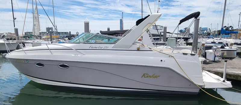 Slide: The Image of 2003 Rinker Fiesta Vee 270 boat docked in a marina, side view. - 11