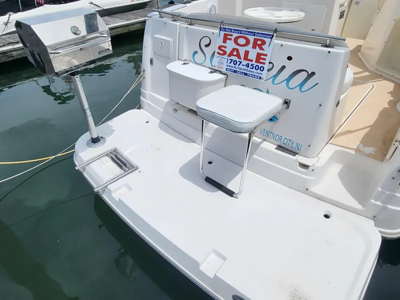 Slide: The Image of 2003 Rinker Fiesta Vee 270 boat for sale, docked with grill and seating. - 12