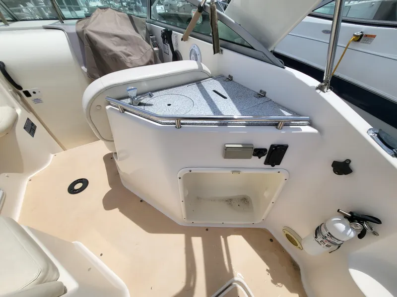 Slide: The Image of 2003 Rinker Fiesta Vee 270 boat interior with seating and storage area. - 16