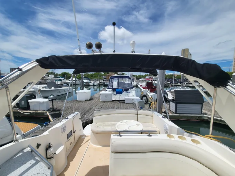 Slide: The Image of 2003 Rinker Fiesta Vee 270 boat docked at marina under blue sky. - 19