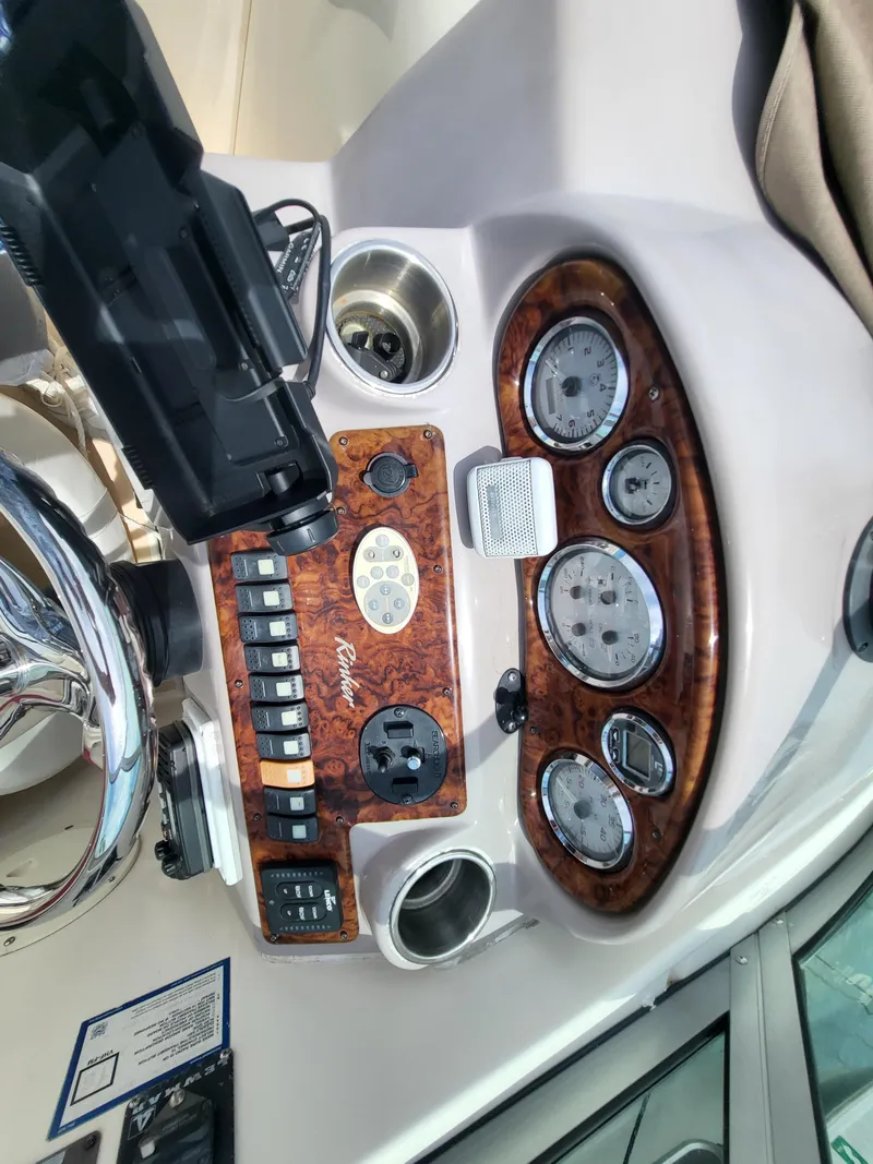 Slide: The Image of 2003 Rinker Fiesta Vee 270 dashboard with gauges and controls. - 20