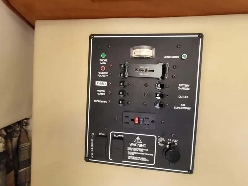 Slide: The Image of Control panel of a 2003 Rinker Fiesta Vee 270 boat, featuring various switches and indicators. - 26