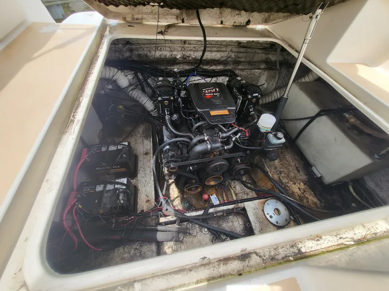 Slide: The Image of 2003 Rinker Fiesta Vee 270 engine compartment with visible wiring and components. - 29
