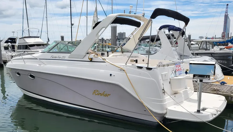Slide: The Image of 2003 Rinker Fiesta Vee 270 boat docked, white exterior, for sale sign visible. - 3