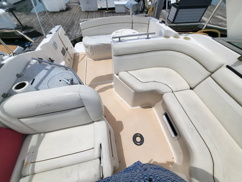 Slide: The Image of 2003 Rinker Fiesta Vee 270 boat interior with white seating and deck view. - 9