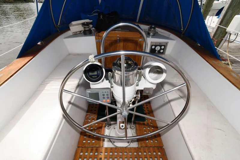 Slide: The Image of 1977 Gulfstar 50 Center Cockpit helm with navigation instruments and wooden accents. - 10