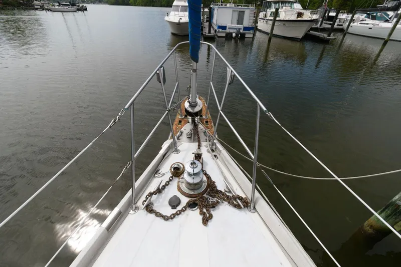 Slide: The Image of Bow of 1977 Gulfstar 50 Center Cockpit sailboat docked in a marina. - 12