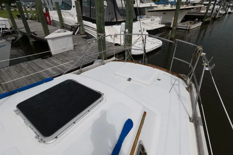 Slide: The Image of 1977 Gulfstar 50 Center Cockpit sailboat docked at a marina. - 15