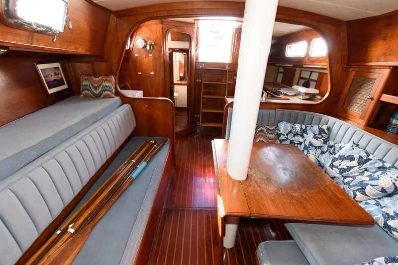 Slide: The Image of 1977 Gulfstar 50 Center Cockpit interior with wooden finishes and seating area. - 18