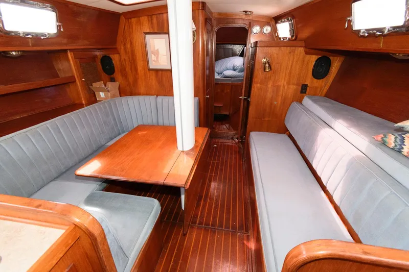 Slide: The Image of 1977 Gulfstar 50 Center Cockpit interior with wooden finishes and blue seating. - 20