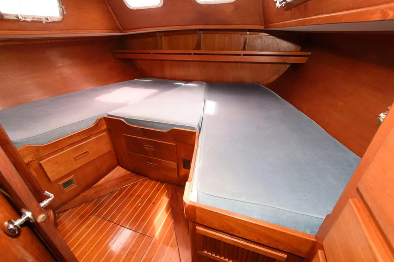 Slide: The Image of 1977 Gulfstar 50 Center Cockpit interior with twin beds and wooden cabinetry. - 25