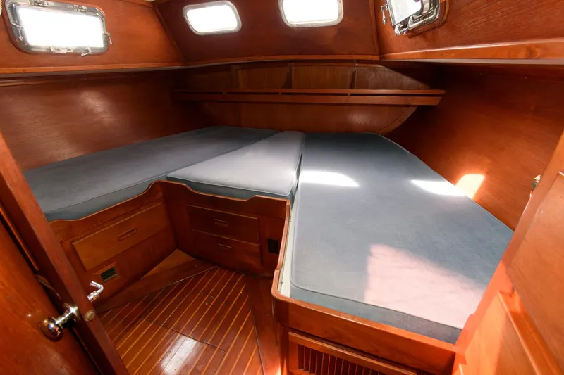 Slide: The Image of 1977 Gulfstar 50 Center Cockpit interior cabin with twin beds and wooden finish. - 32