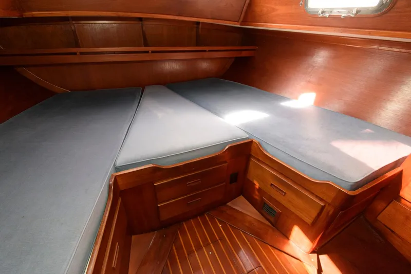 Slide: The Image of 1977 Gulfstar 50 Center Cockpit interior cabin with wooden finish and cushioned seating. - 34