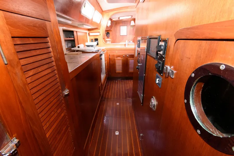 Slide: The Image of 1977 Gulfstar 50 Center Cockpit interior with wooden cabinetry and flooring. - 35