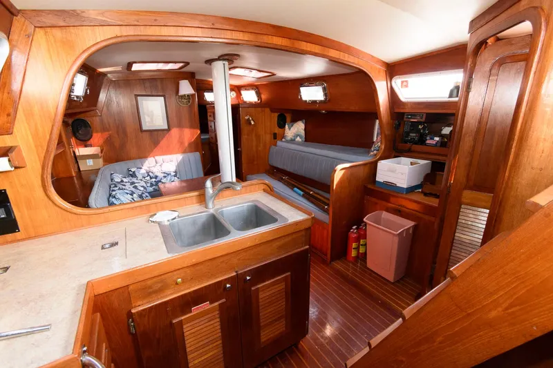 Slide: The Image of Interior of 1977 Gulfstar 50 Center Cockpit sailboat with wooden finishes and cozy living space. - 38
