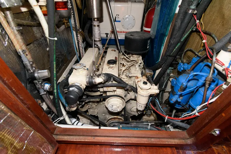 Slide: The Image of 1977 Gulfstar 50 Center Cockpit engine compartment with visible machinery and wiring. - 40
