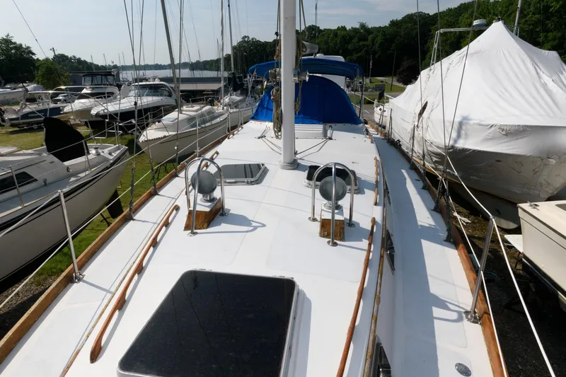 Slide: The Image of 1977 Gulfstar 50 Center Cockpit sailboat docked among other boats. - 7