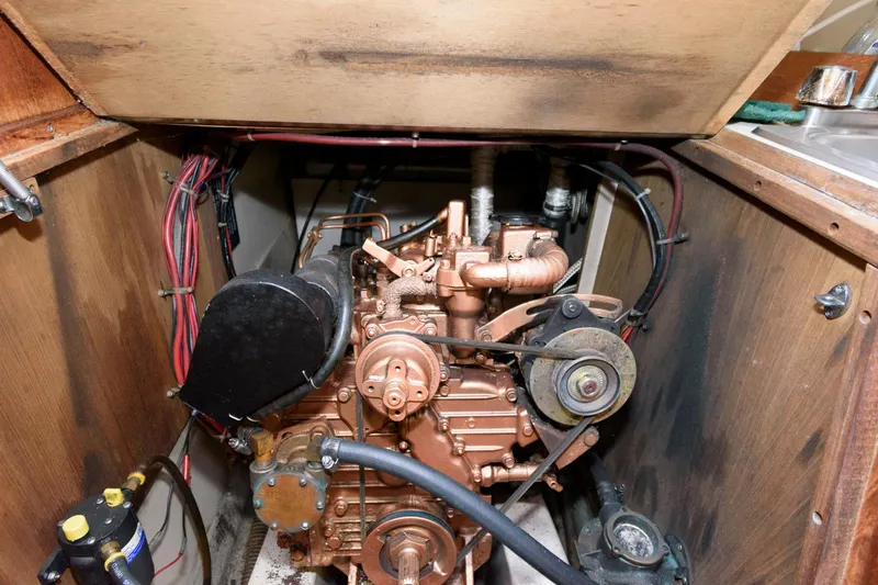 Slide: The Image of 1983 O'Day 30 sailboat engine compartment with visible wiring and components. - 17