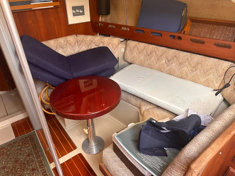 Slide: The Image of Interior of 1983 O'Day 30 sailboat with seating area and wooden table. - 9