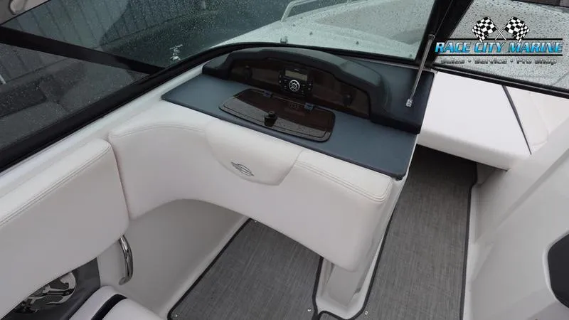 Slide: The Image of 2020 Chaparral 237 SSX boat interior with white seating and dashboard. - 10