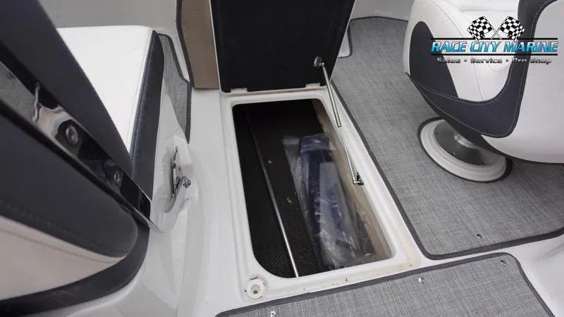 Slide: The Image of 2020 Chaparral 237 SSX boat interior storage compartment with Race City Marine logo. - 11