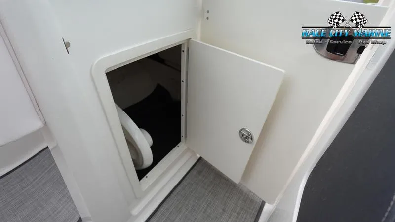 Slide: The Image of Open storage compartment on a 2020 Chaparral 237 SSX boat. - 12