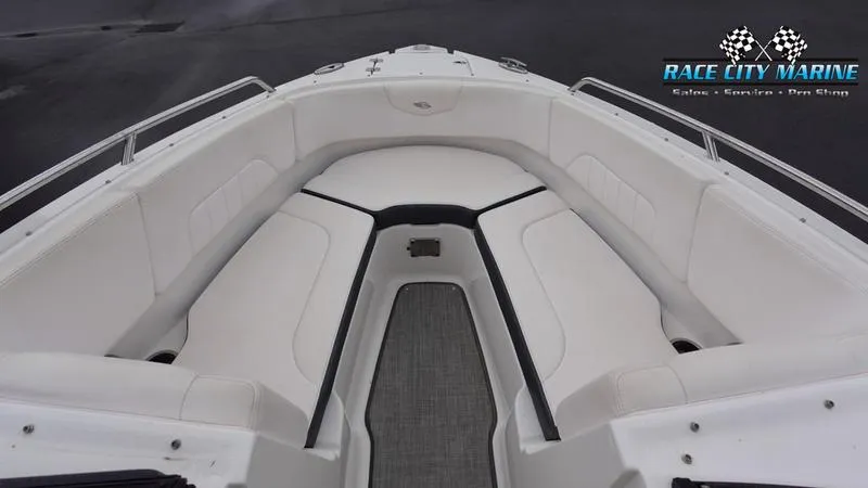 Slide: The Image of 2020 Chaparral 237 SSX boat interior with white seating and Race City Marine logo. - 17