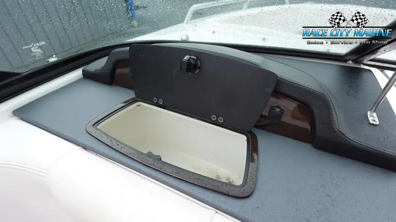 Slide: The Image of 2020 Chaparral 237 SSX boat dashboard storage compartment with Race City Marine logo. - 19